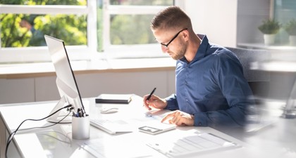 Man filing taxes at a desk