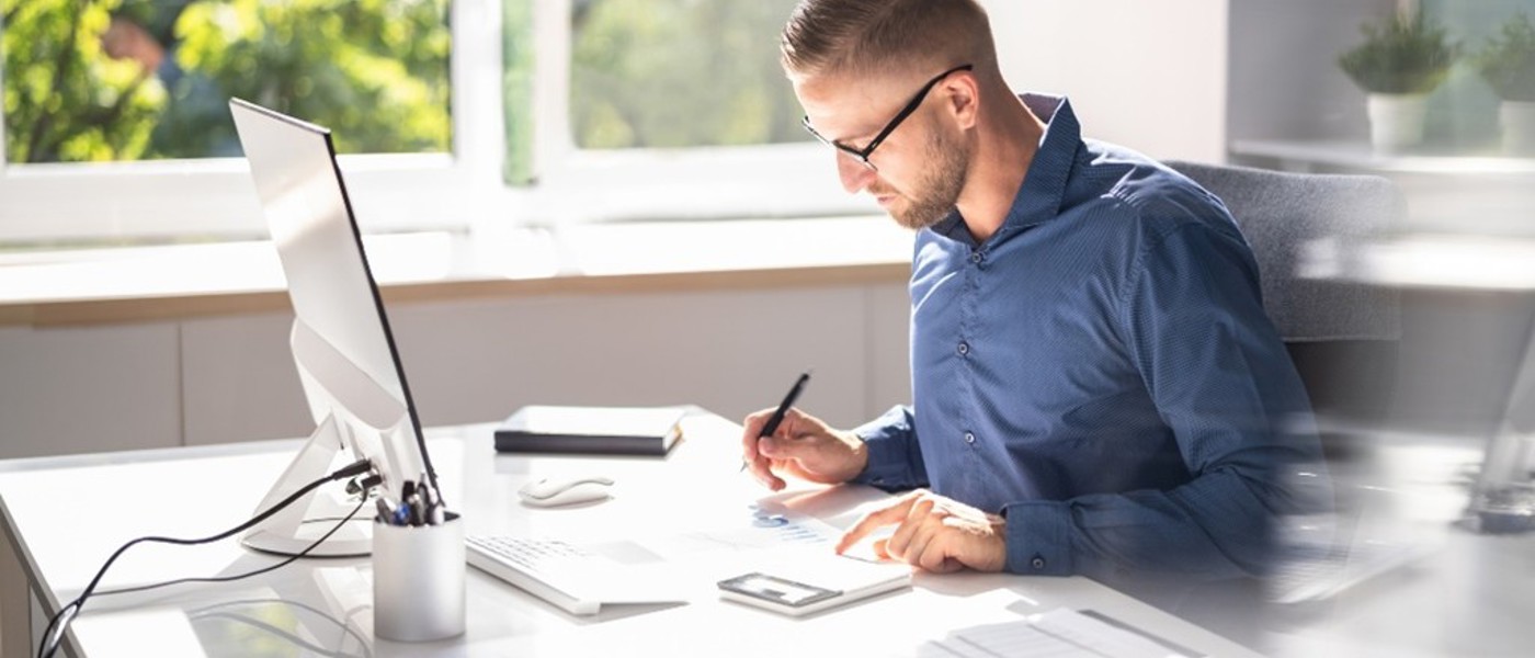 Man filing taxes at a desk