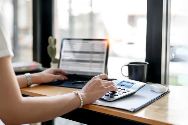 Woman using a calculator at her desk